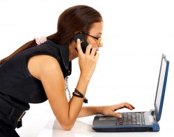 Young Woman On The Telephone And Computer